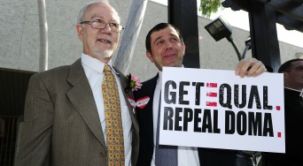Same-sex couple with Repeal DOMA sign