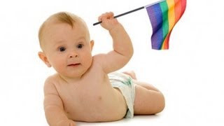 Baby holding rainbow Pride flag