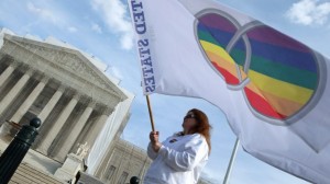 Marriage equality protester with rainbow flag outside US Supreme Court