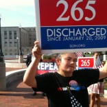 DADT discharge protester with sign
