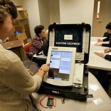 Woman using voting machine