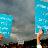 Protestors hold signs supporting same-sex marriage