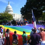 LGBT rally with large rainbow flag in front of US Capitol