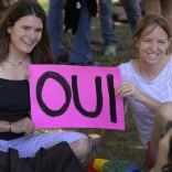 Two women with sign that says OUI