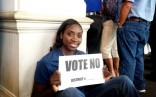 Sophia Young holding Vote No sign