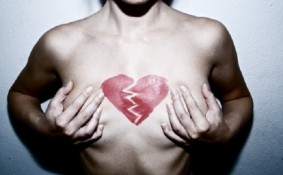 Woman with broken heart on her chest