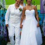 Kimberly, left, and Katie are all smiles despite the sentiments of the Westboro Baptist Church across the street. (Photo: Chris Neal/The Capital-Journal)