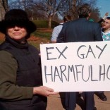 Woman with anti-ex-gay therapy sign