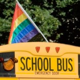 Gay pride flag on top of a school bus