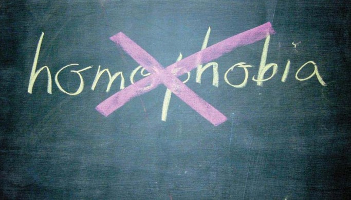 Homophobia written on chalkboard and crossed out