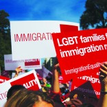 Protestors holding signs for LGBT immigration reform