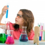 Little girl with beakers