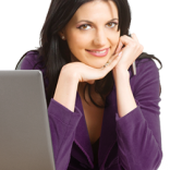 Woman on computer and smiling