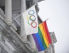 A rainbow flag flying over city hall alongside the Olympic flag in Montreal, Canada during the Sochi Olympics. (Photo: The Canadian Press/Graham Hughes)