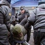Gay rights activist in Russia surrounded by police.