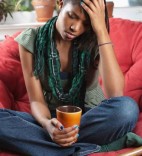 sad girl on a red couch