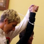 Lesbian Austrian couple raise hands in solidarity