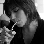 Woman lighting cigarette