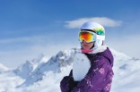 woman snowboarding with rainbow goggles