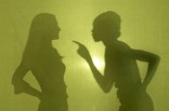 Silhouette of two women arguing